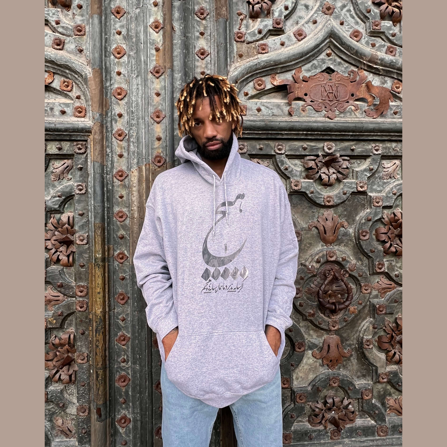Gray unisex hoodie with ‘Hich’ Farsi calligraphy design – minimalist Persian typography sweatshirt, cultural streetwear for men and women, perfect for fashion lovers in USA and Canada.