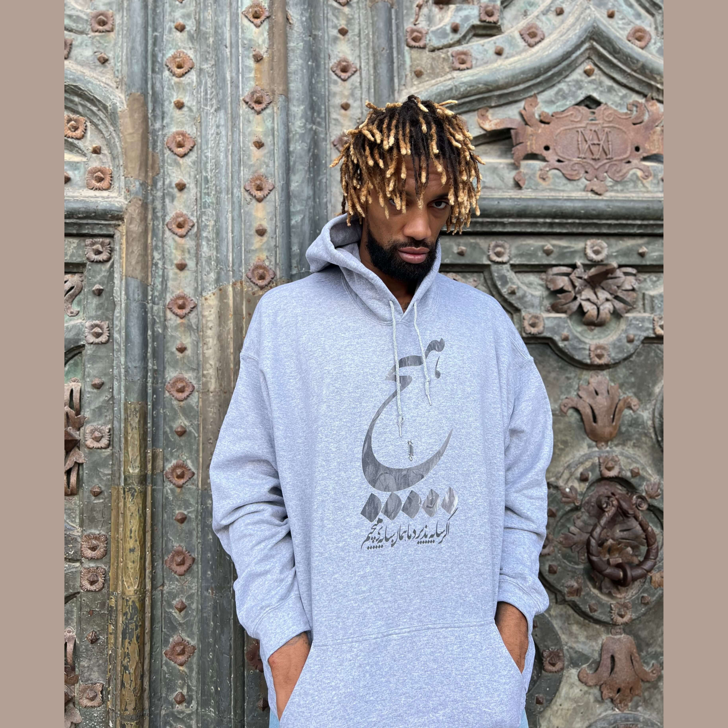 Gray streetwear hoodie with bold ‘Hich’ Farsi calligraphy – unique Persian graphic sweatshirt for men and women, trending minimalist fashion USA & Canada.