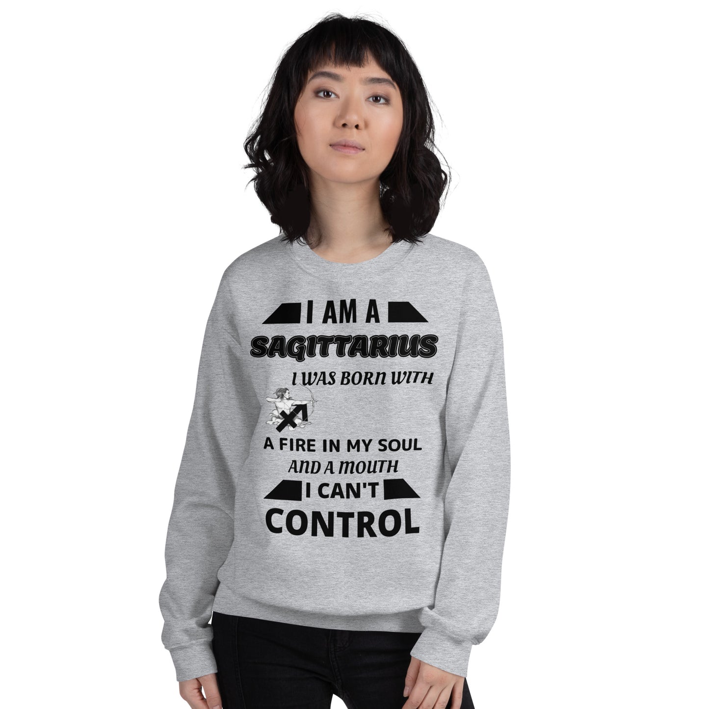 Woman wearing grey Sagittarius zodiac sweatshirt with bold quote – I was born with fire in my soul and a mouth I can’t control – standing in front of red sports car, casual astrology-themed fashion.