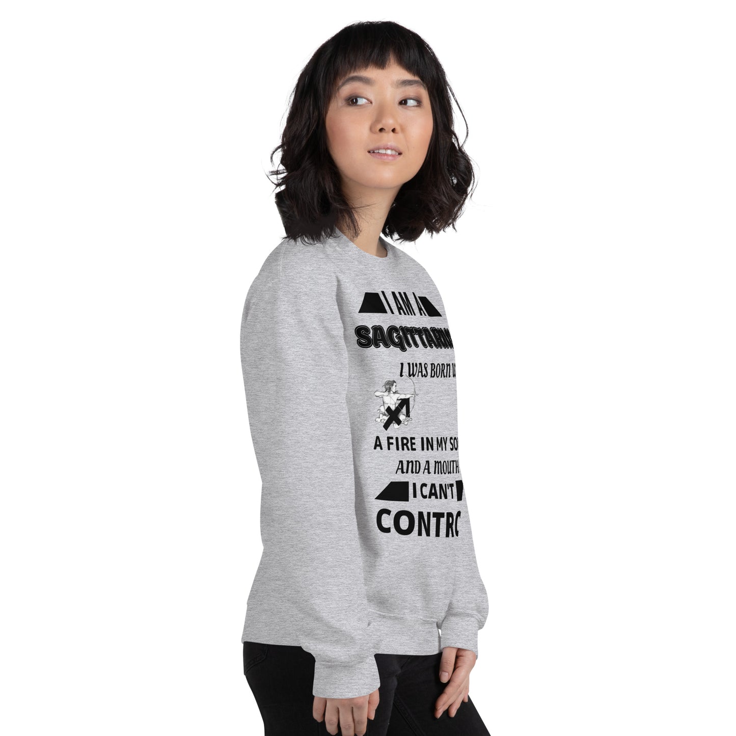 Woman wearing grey Sagittarius zodiac sweatshirt with bold quote – I was born with fire in my soul and a mouth I can’t control – standing in front of red sports car, casual astrology-themed fashion.