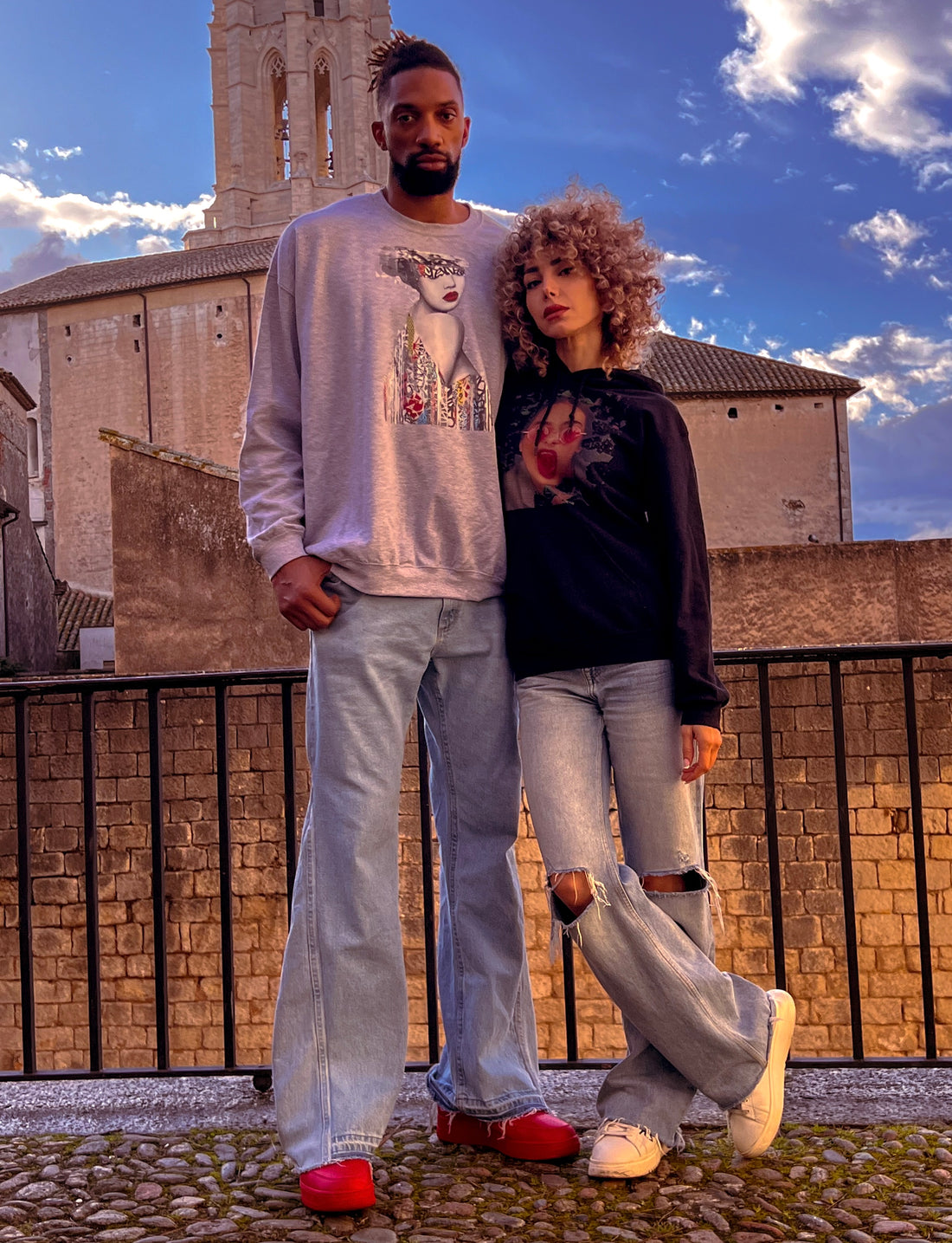 the former NBA star, alongside the captivating model and actress Salome Saliya wearing stylish sweaters from ONLYZ3AL, standing in front of a historic building.
