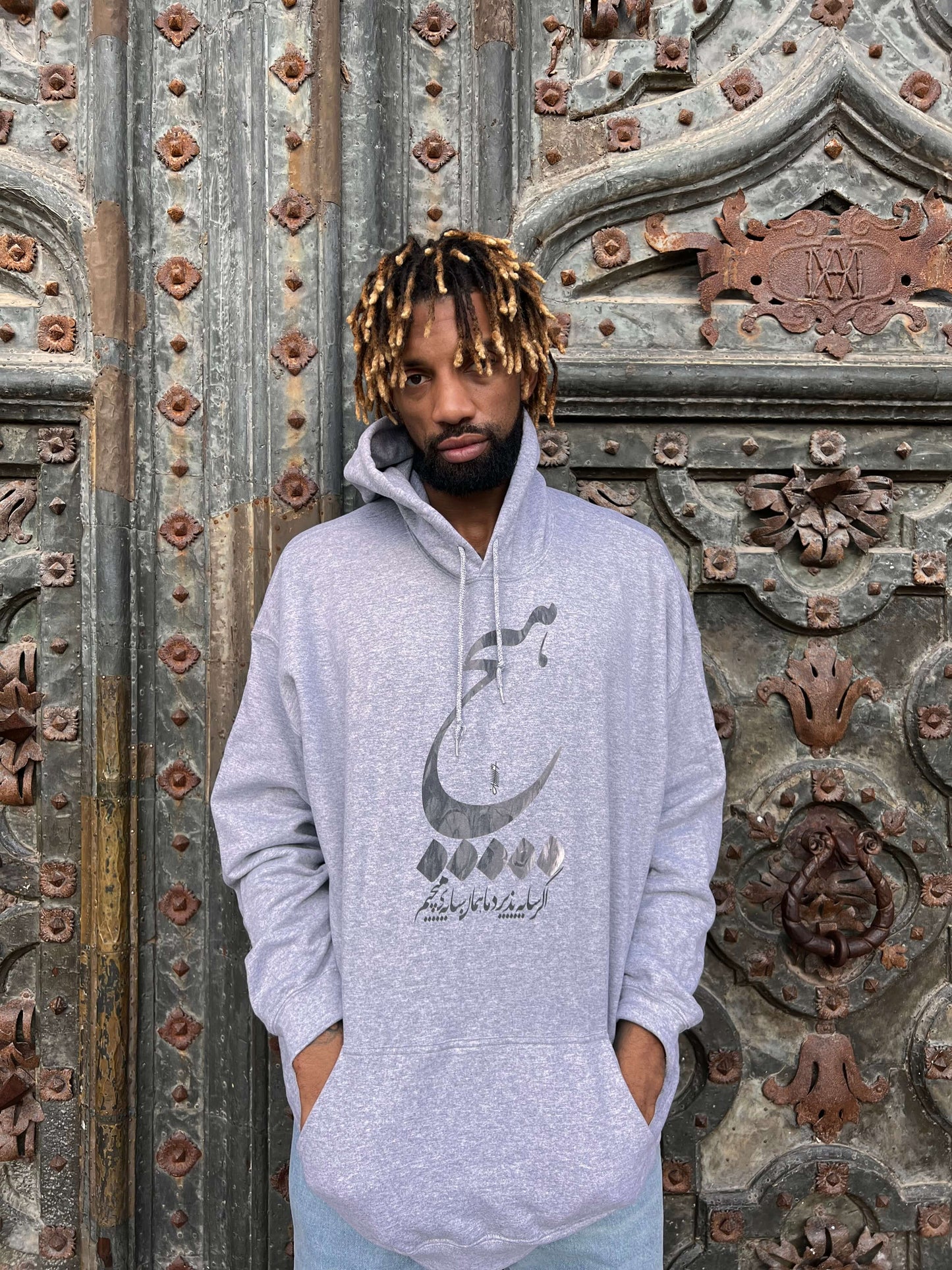 Khem birch is wearing Cozy hoodie in muted grey, styled with elegance.