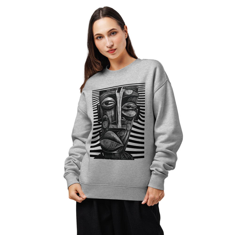 Woman wearing a gray sweatshirt with a black and white abstract face design on a white background